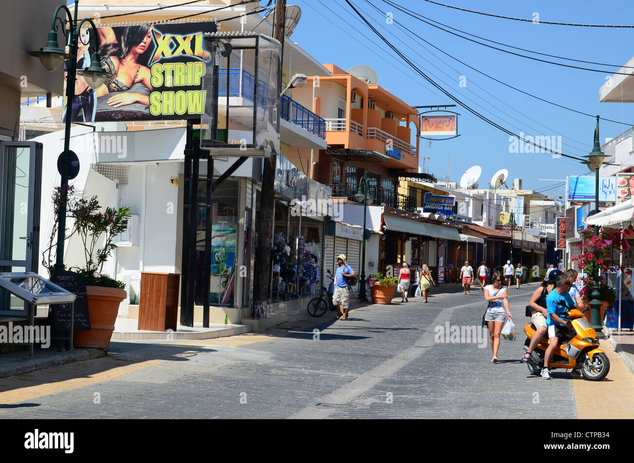A lively street in the fun town of Faliraki on the Greek Island of Rhodes Stock Photo