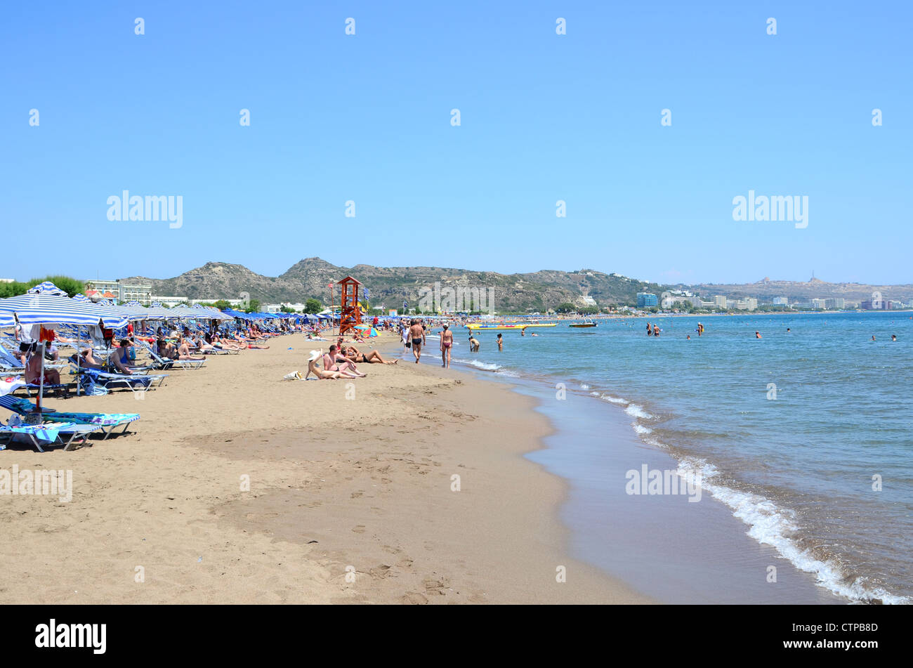 The beach in the fun and lively resort of Faliraki on the popular Greek Island of Rhodes Stock Photo