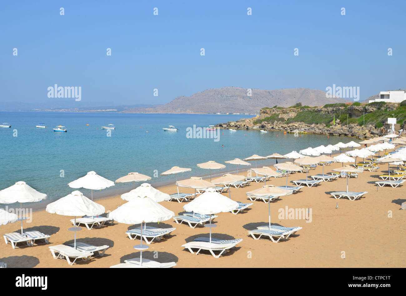 The popular sandy beach at Pefkos on the Greek Island of Rhodes. Stock Photo