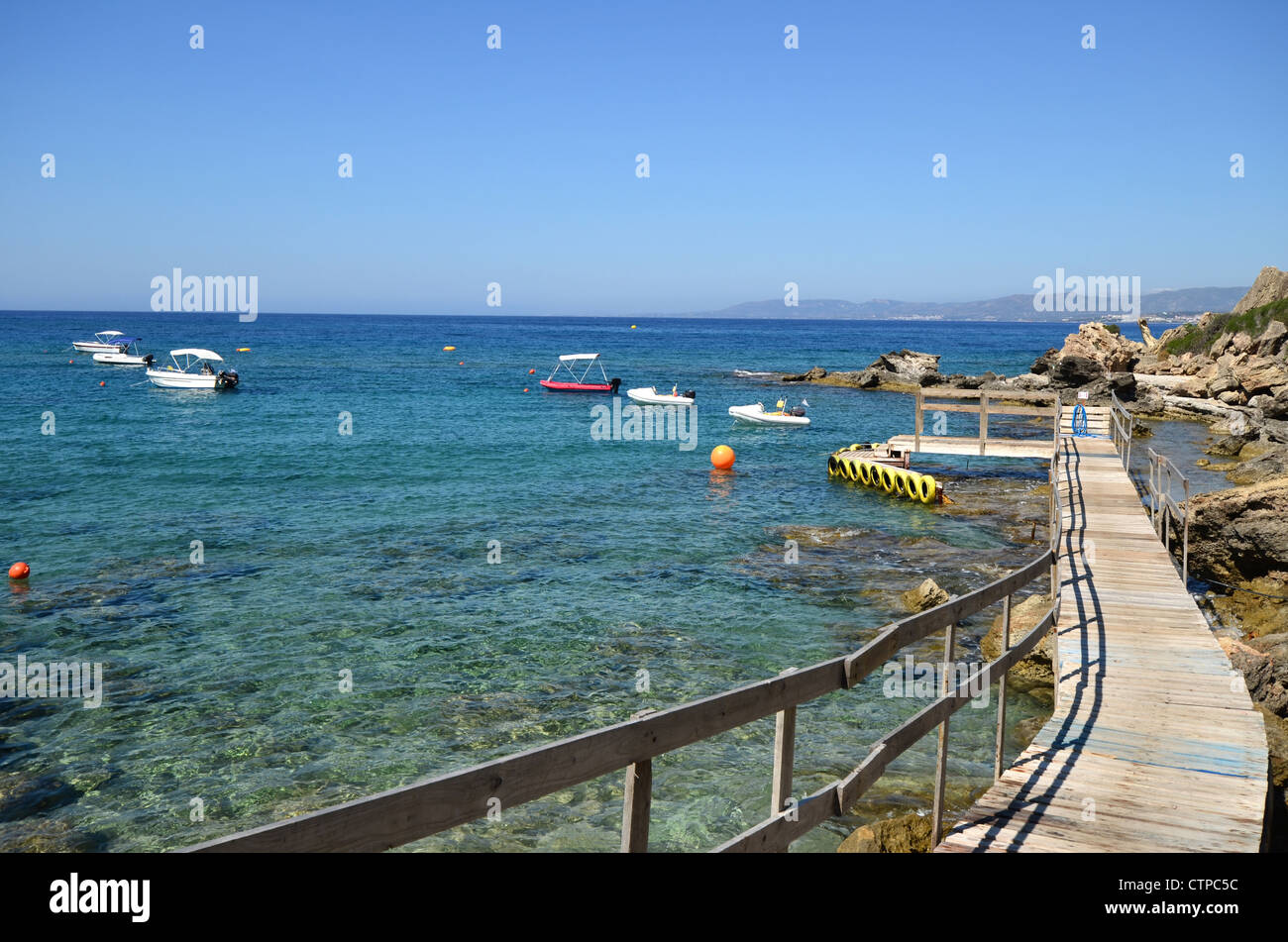 A wooden jetty on Pefkos beach on the Greek Island of Rhodes Stock Photo