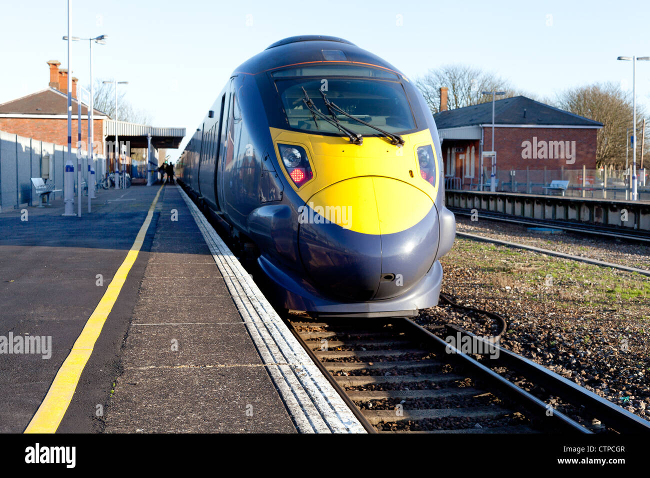 A high speed electric train stopped at a railway station Stock Photo