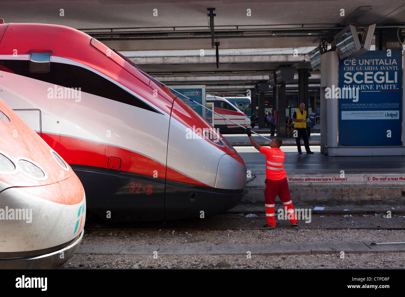 Maintenance operator cleans window of Italian high speed train Stock Photo