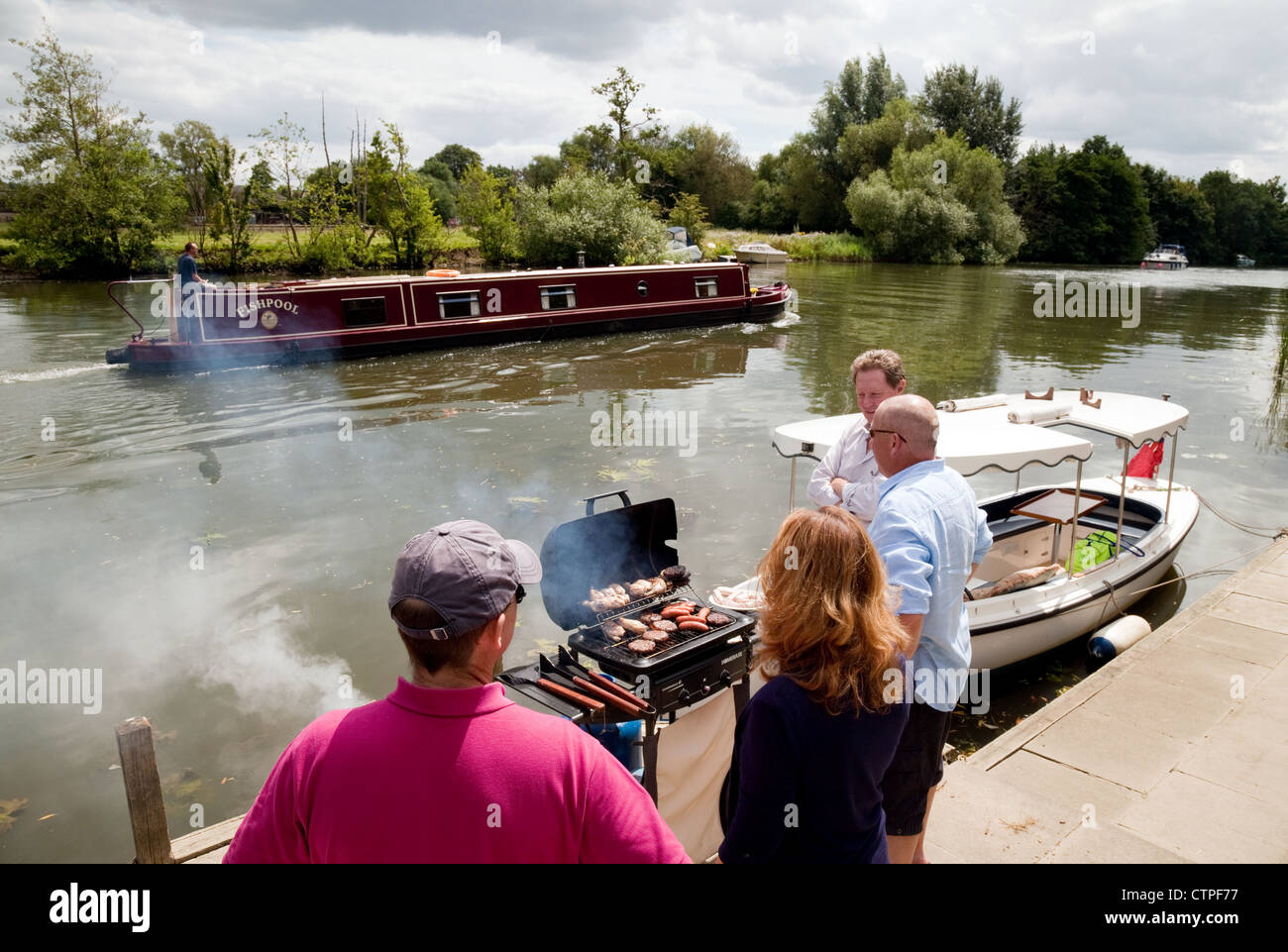 A family barbecue bbq party on the River Thames in Oxfordshire UK Stock