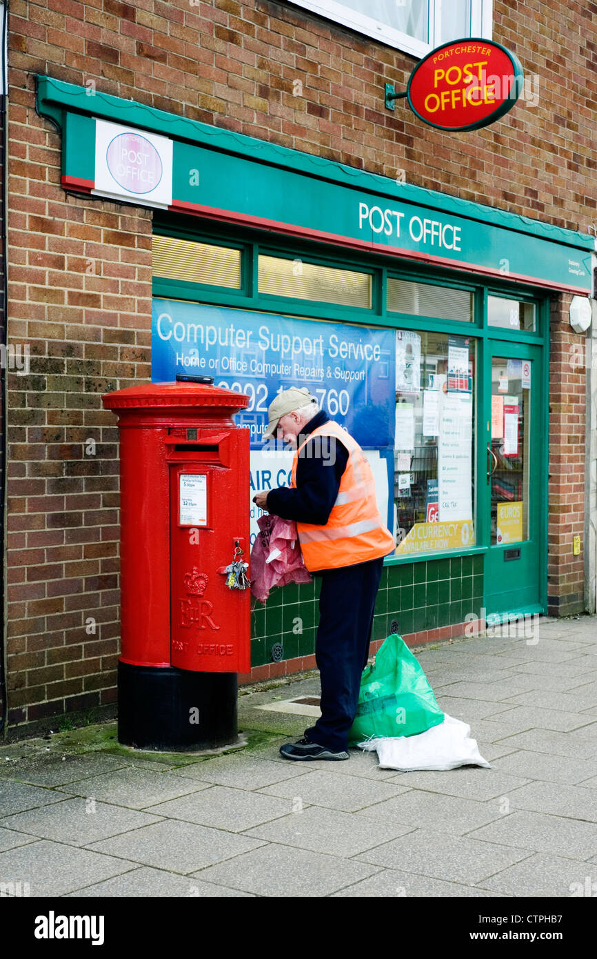 postman emptying post box outside of post office Stock Photo 49669067