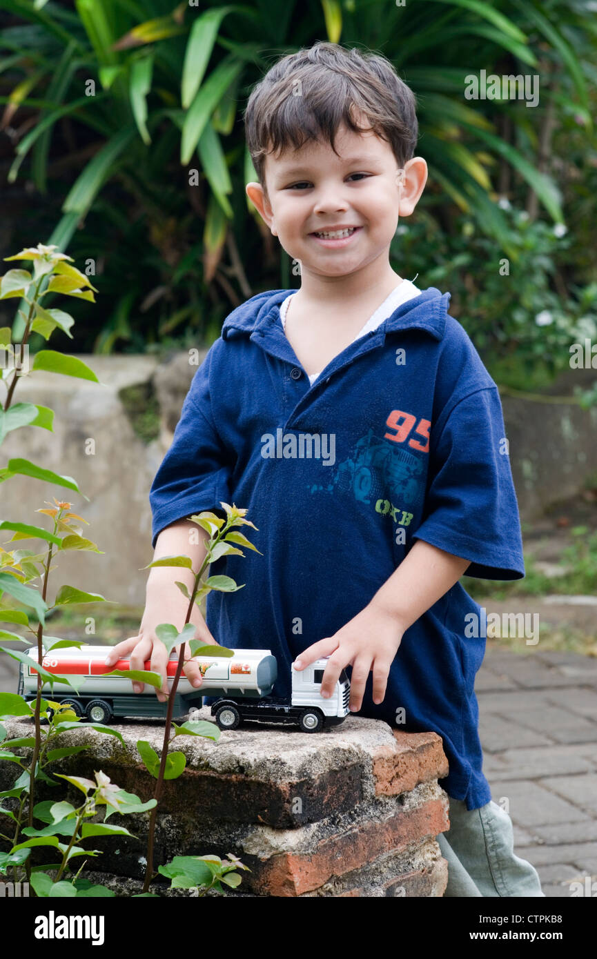 little boy playing with his toy cars in garden Stock Photo - Alamy