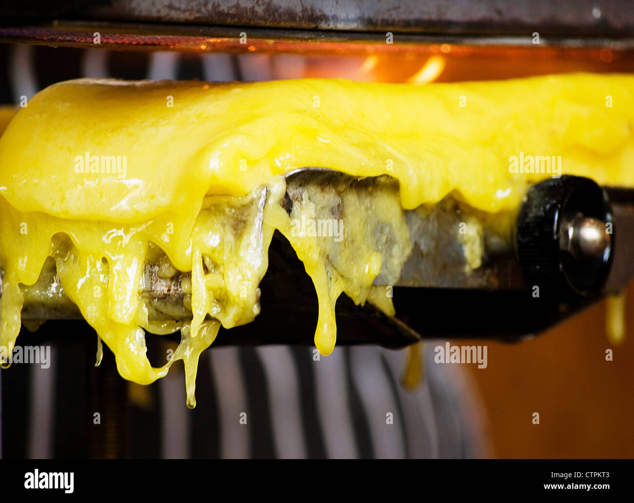 grill melting cheddar cheese for meals close up Stock Photo Alamy