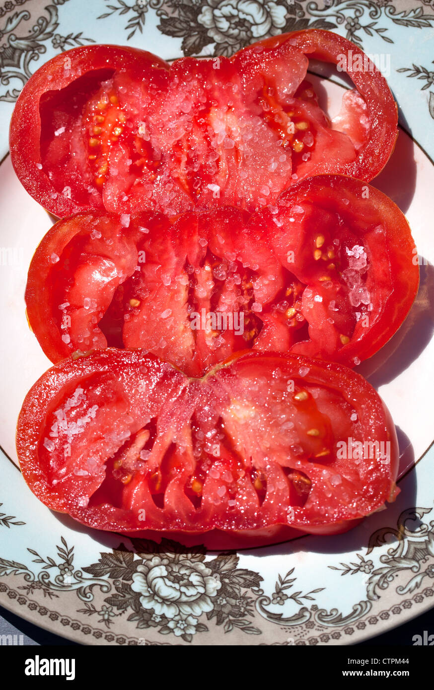 Slices of Pink Beef or Zapotec Pleated Tomato with Sea Salt Stock Photo
