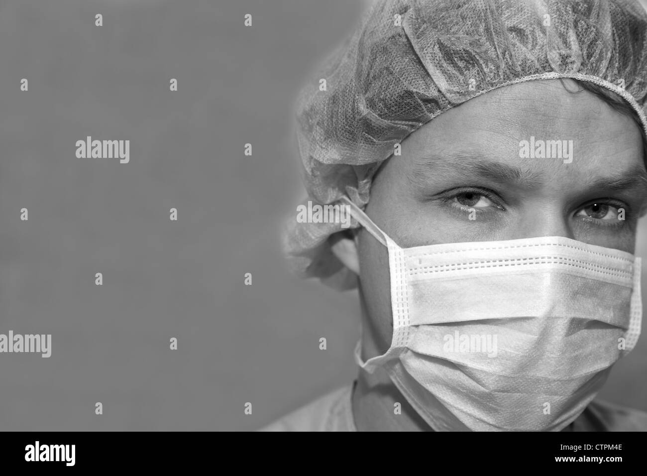 Shaded surgeon zoomed face before coming difficult surgery Stock Photo
