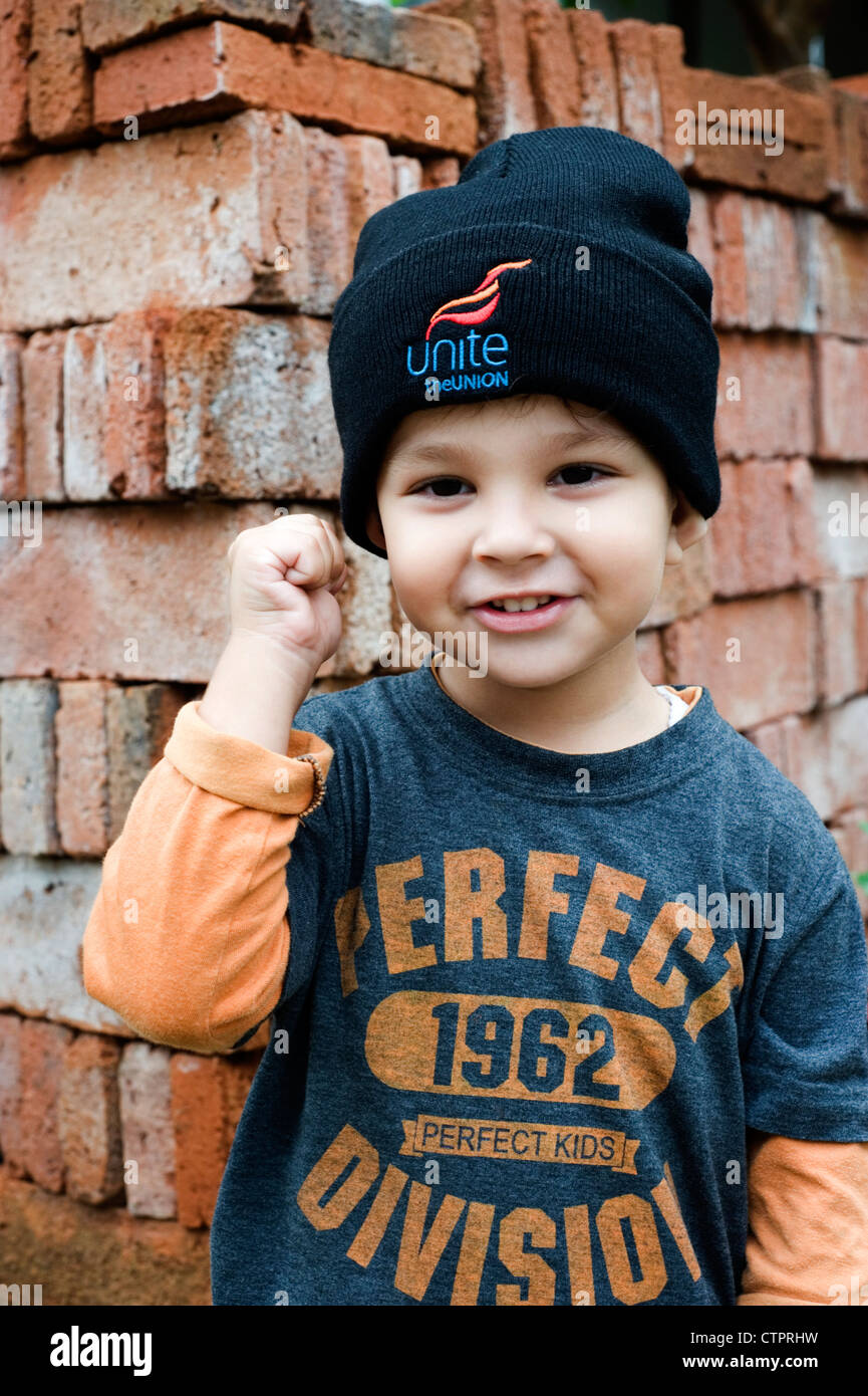 young mixed race boy with clenched fist and wearing a unite union hat Stock Photo