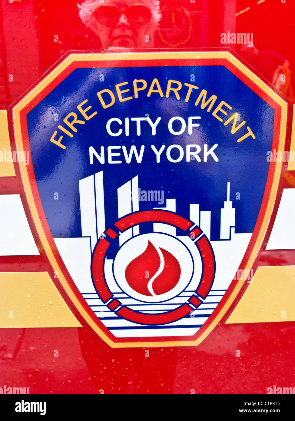 red white blue & gold City of New York Fire Department FDNY logo on side of freshly washed fire rescue truck firetruck Manhattan Stock Photo