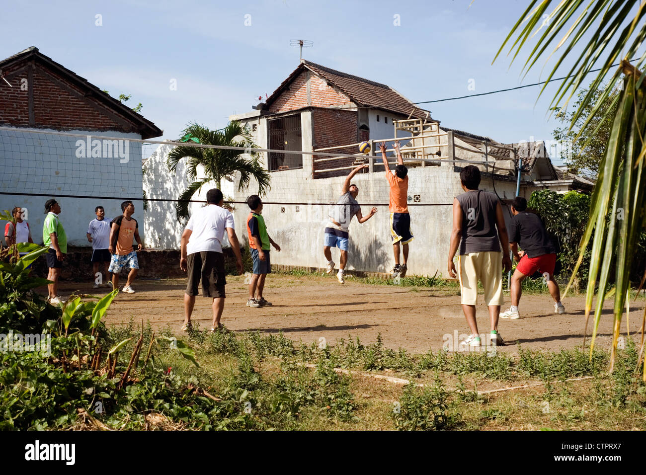 local villagers playing volleyball on waste land java indonesia Stock