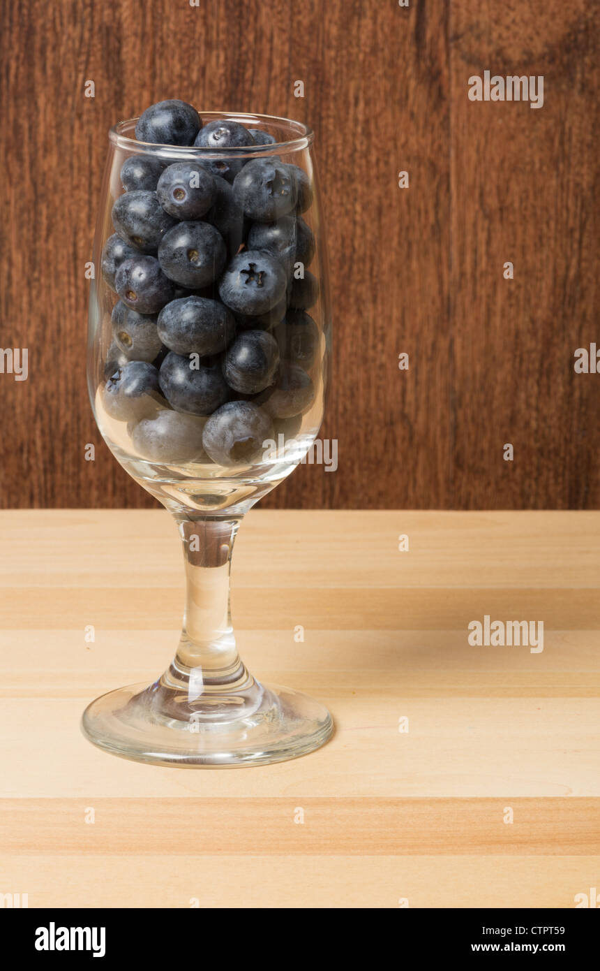 Blueberries in wine glass on reflective surface Stock Photo Alamy