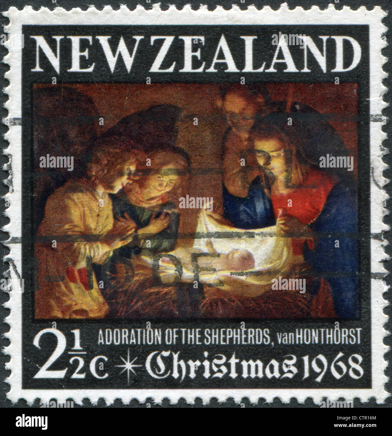 A stamp printed in New Zealand, dedicated to the Christmas, shows Adoration of the Holy Child by Gerard van Honthorst Stock Photo