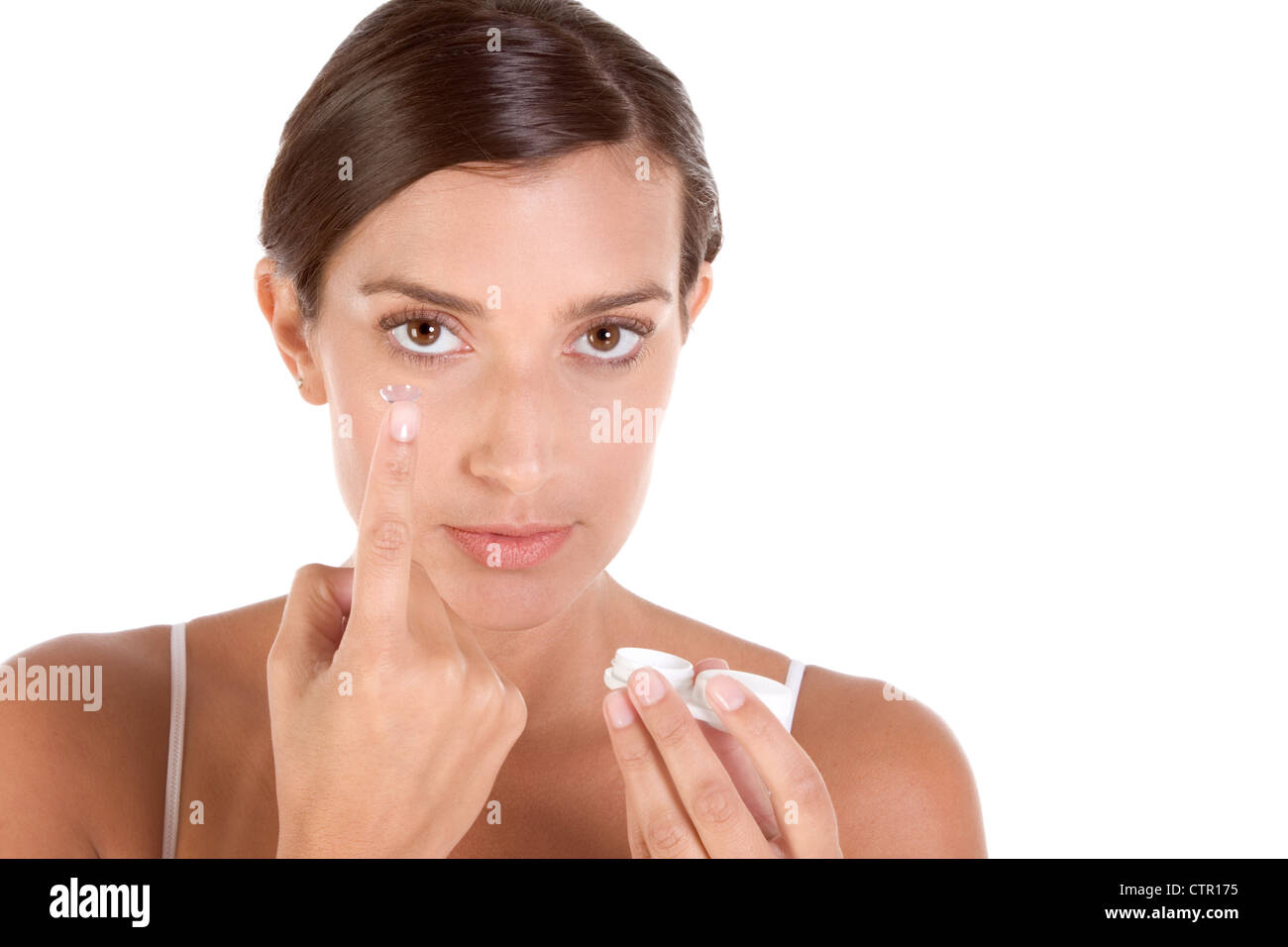 woman putting on contact lenses Stock Photo