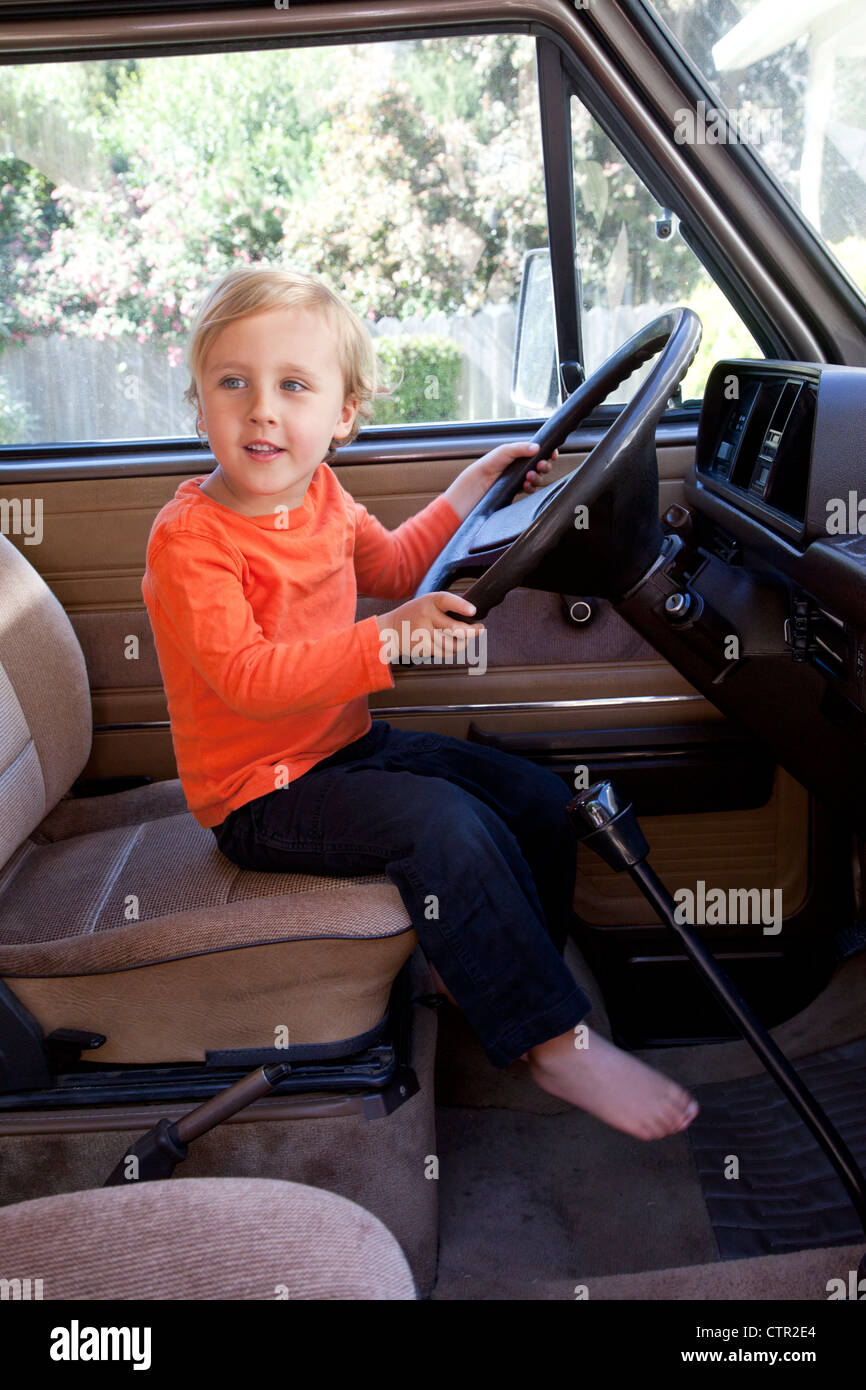 https://c8.alamy.com/comp/CTR2E4/a-little-boy-is-behind-a-steering-wheel-pretending-to-drive-CTR2E4.jpg