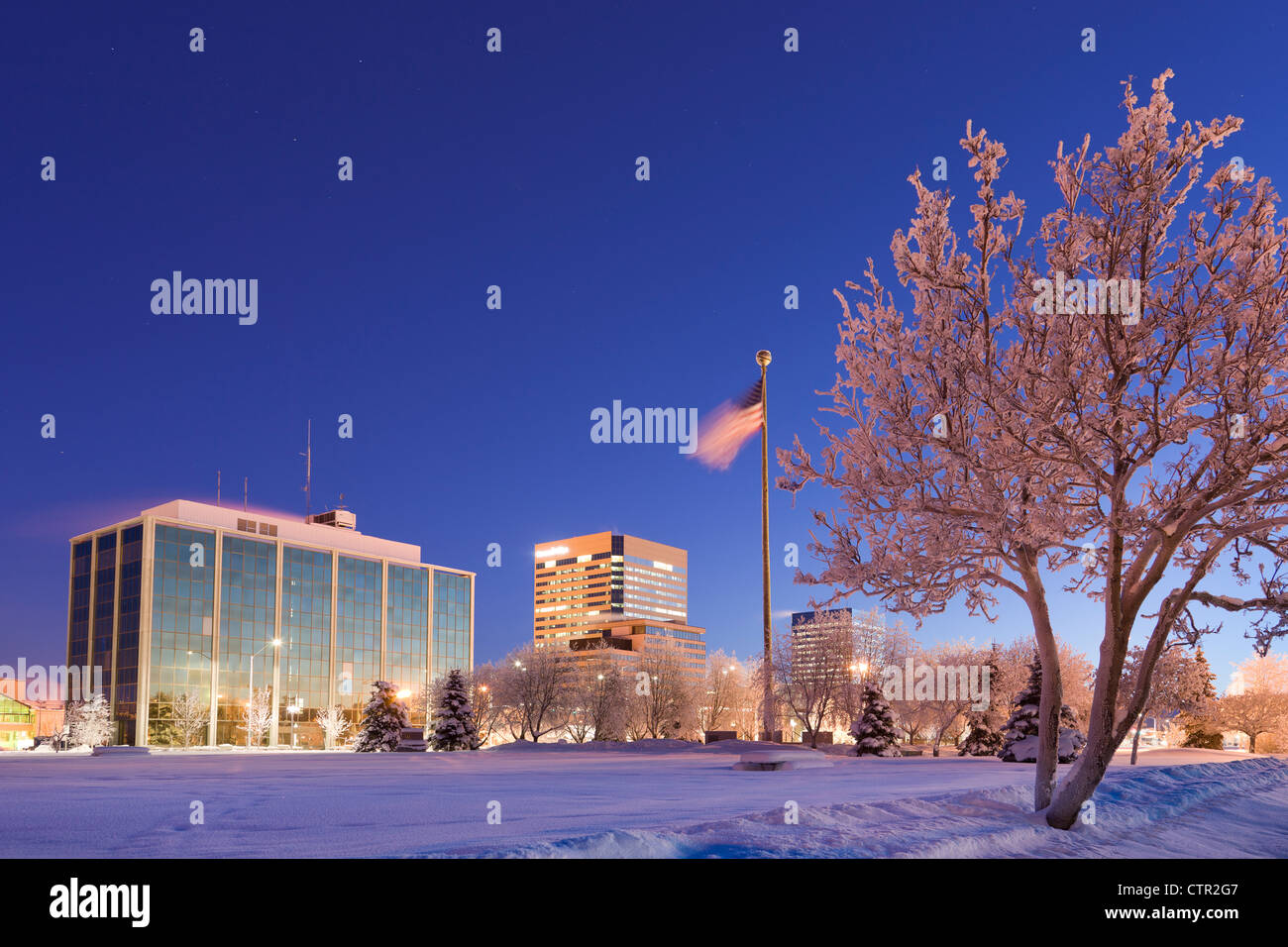 View across the Delaney Parkstrip with downtown Anchorage in the background at twilight,  Southcentral Alaska, Winter Stock Photo