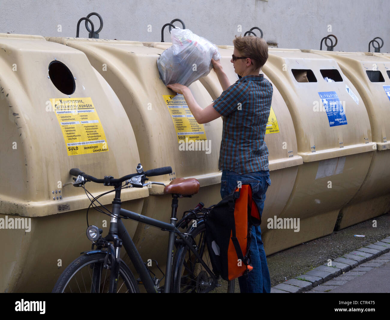 Person putting bag in recycling bins in Memmingen, Germany Stock Photo Alamy