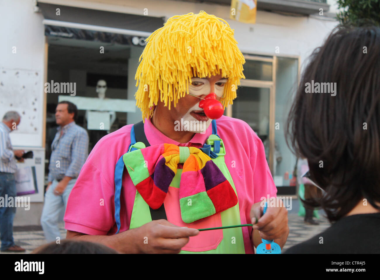 Brightly coloured street clown - Funchal, Madeira Stock Photo
