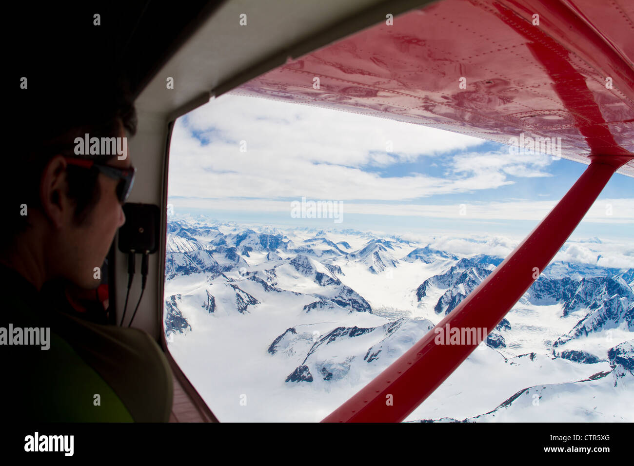 Climber looking out the window from a Turbo Otter at the Wrangell-Saint Elias Mountains, Yukon Territory, Canada, Summer Stock Photo