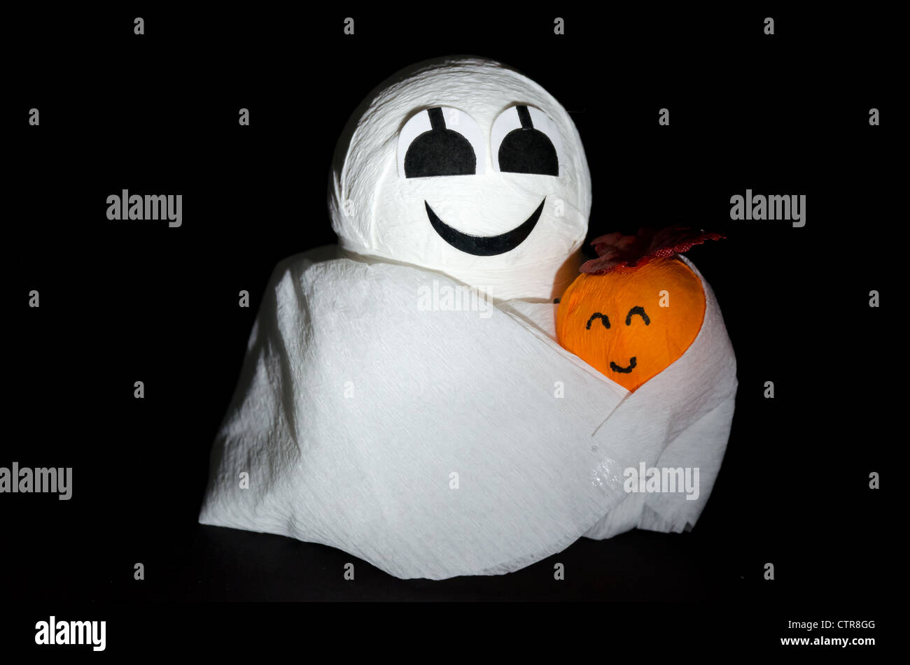 Halloween ghost figure and pumpkin - studio shot with a black background Stock Photo