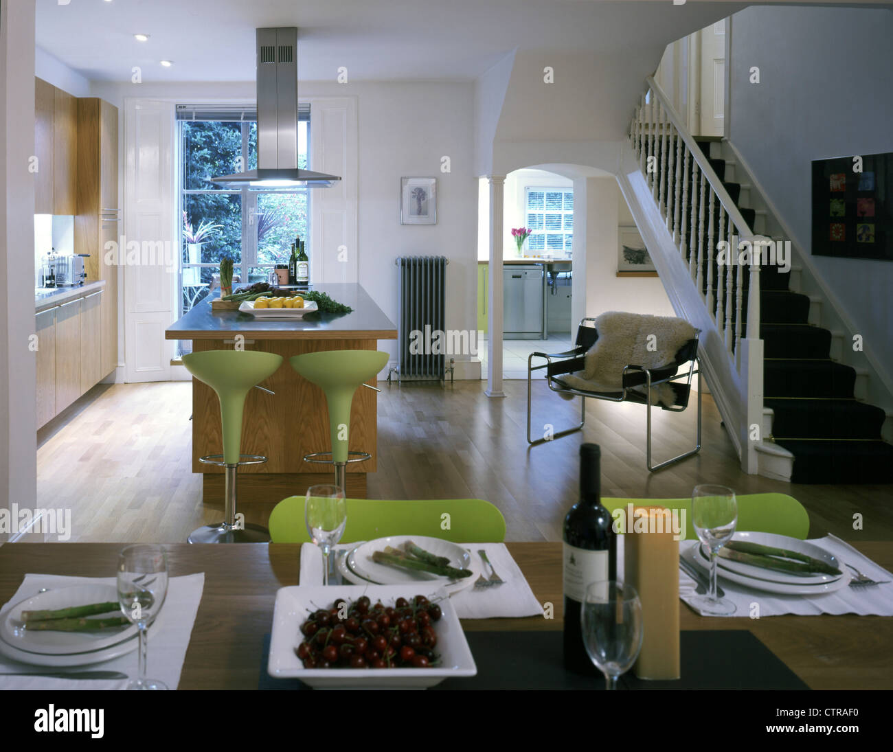 private house view over dining table to kitchen Stock Photo - Alamy