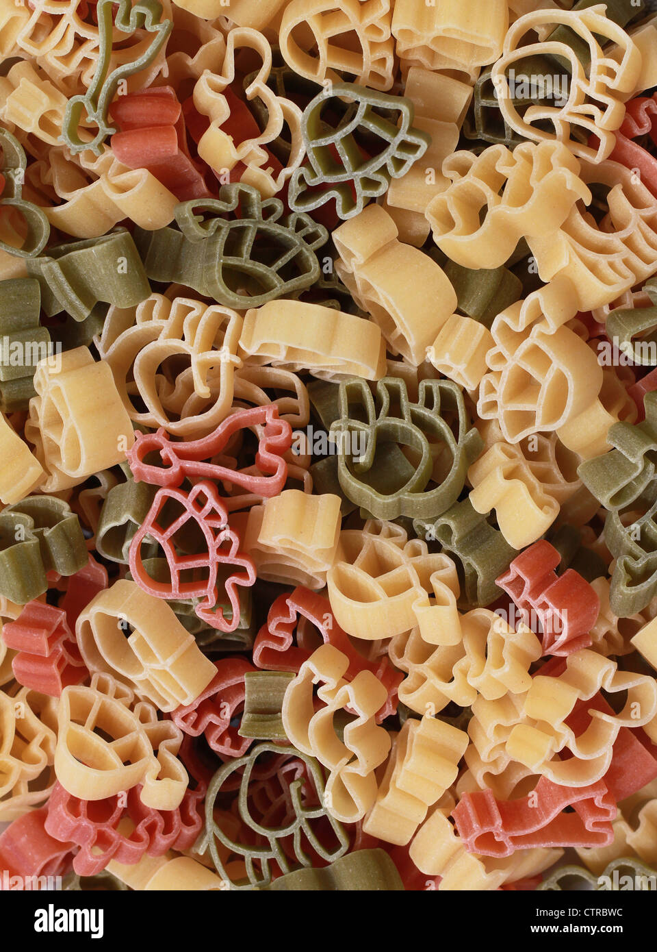 Italian pasta of durum wheat semolina with tomato and spinach in form of various zoo animals. Funny for children. Stock Photo