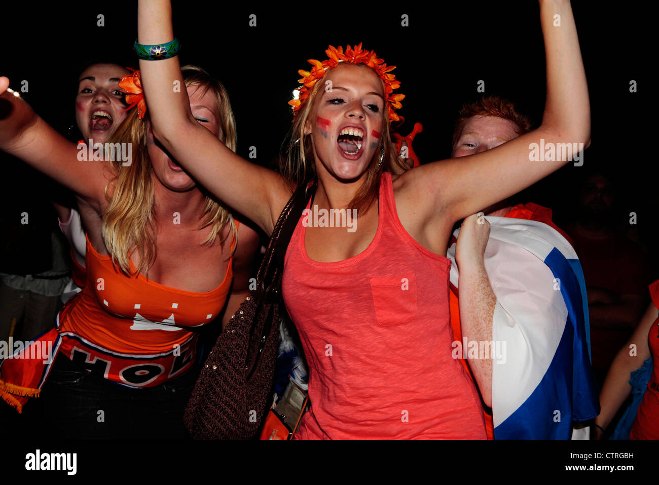 Joyful Dutch football fans celebrate after the Holland soccer team win against Argentina in  World Cup semi finals, 2010 Stock Photo