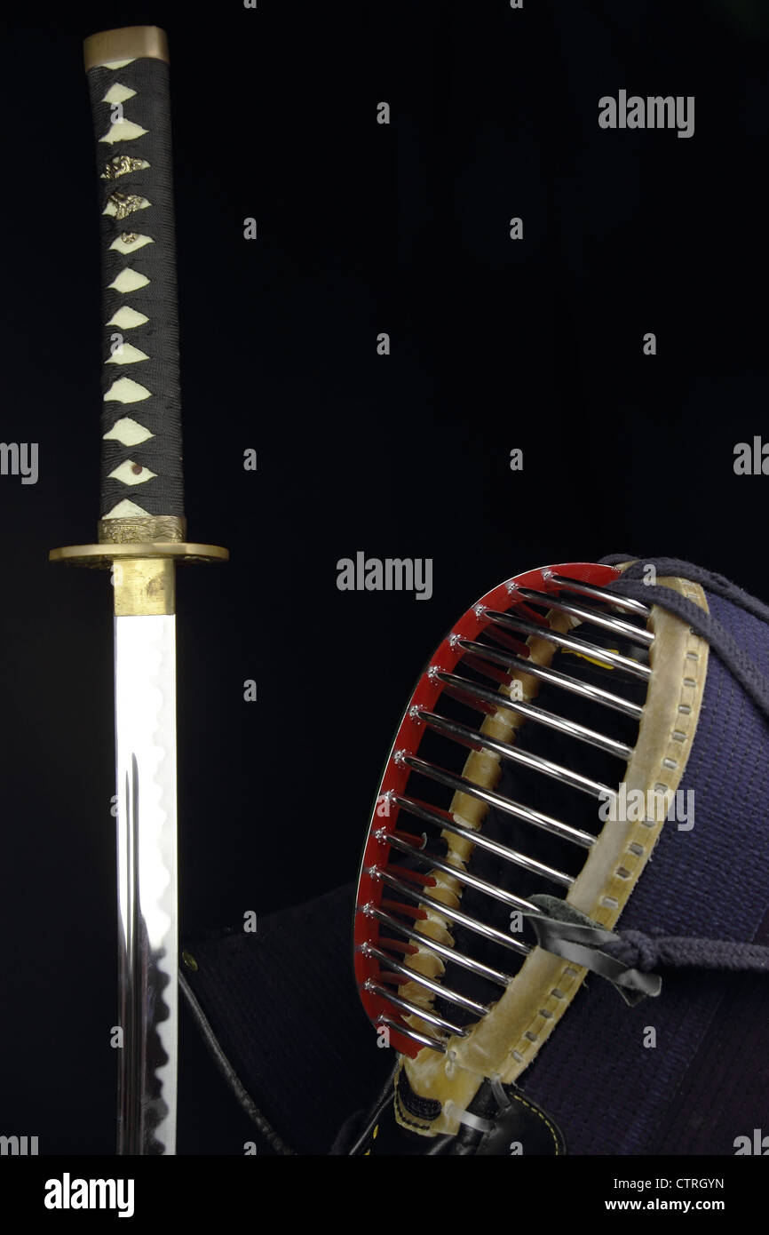 katana sword and kendo helmet over black background Stock Photo