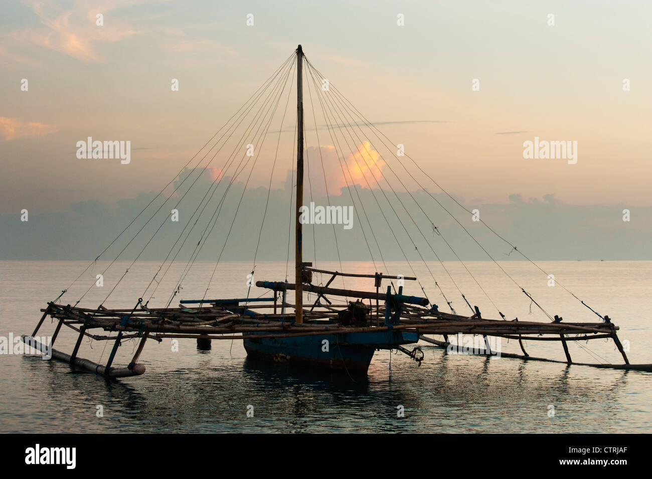 A Balinese fishing boat anchors off the beach in Pemuteran, Bali, Indonesia. These boats fish at