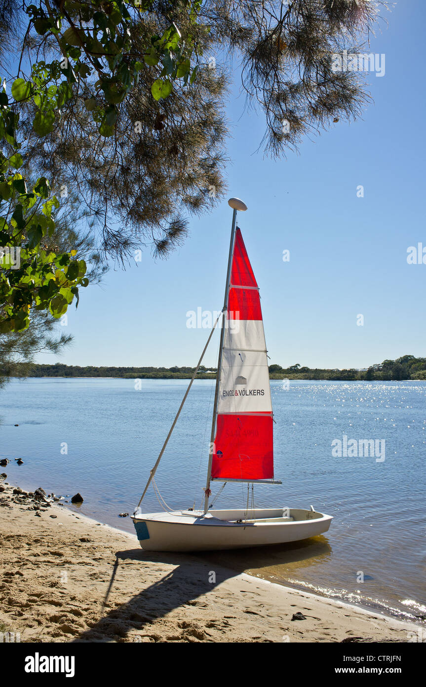 A dinghy beached on the bank of the Maroochy River in Queensland Stock Photo