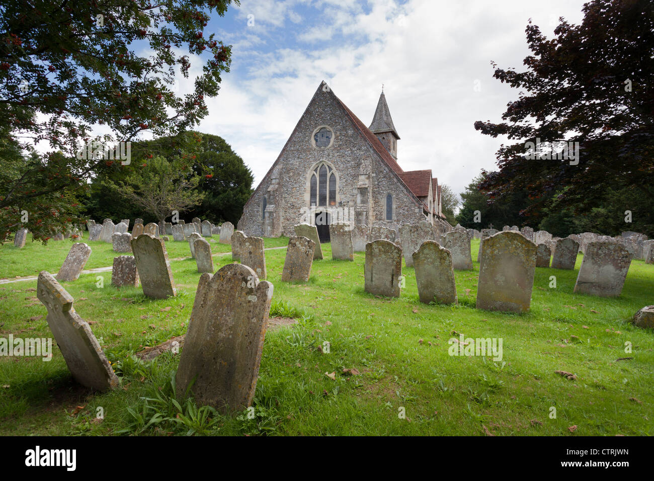 The 12C Church St Thomas à Becket, Warblington and gravestones in the churchyard. Stock Photo