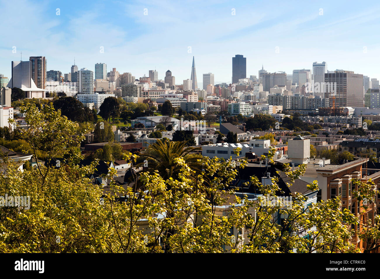 San Francisco skyline as seen from looking out of the top floor of one of the Painted Ladies of Alamo Square. Stock Photo