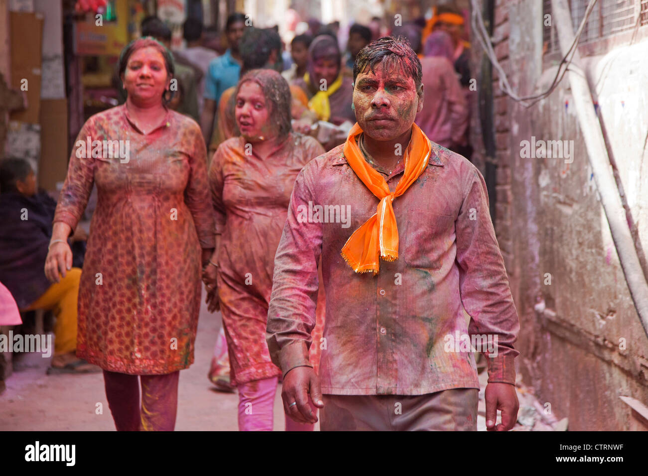 Pilgrims dyed in red celebrating the Holi festival in Vrindavan, Uttar Pradesh, India Stock Photo
