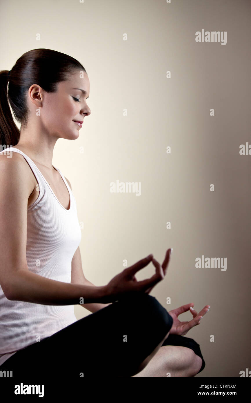 A young woman meditating, eyes closed Stock Photo Alamy