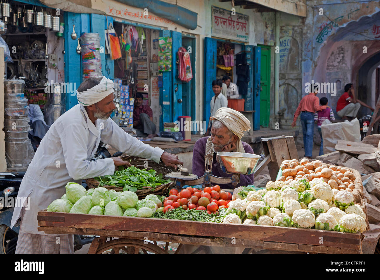 Vendors selling vegetables on wooden cart at market in Barsana
