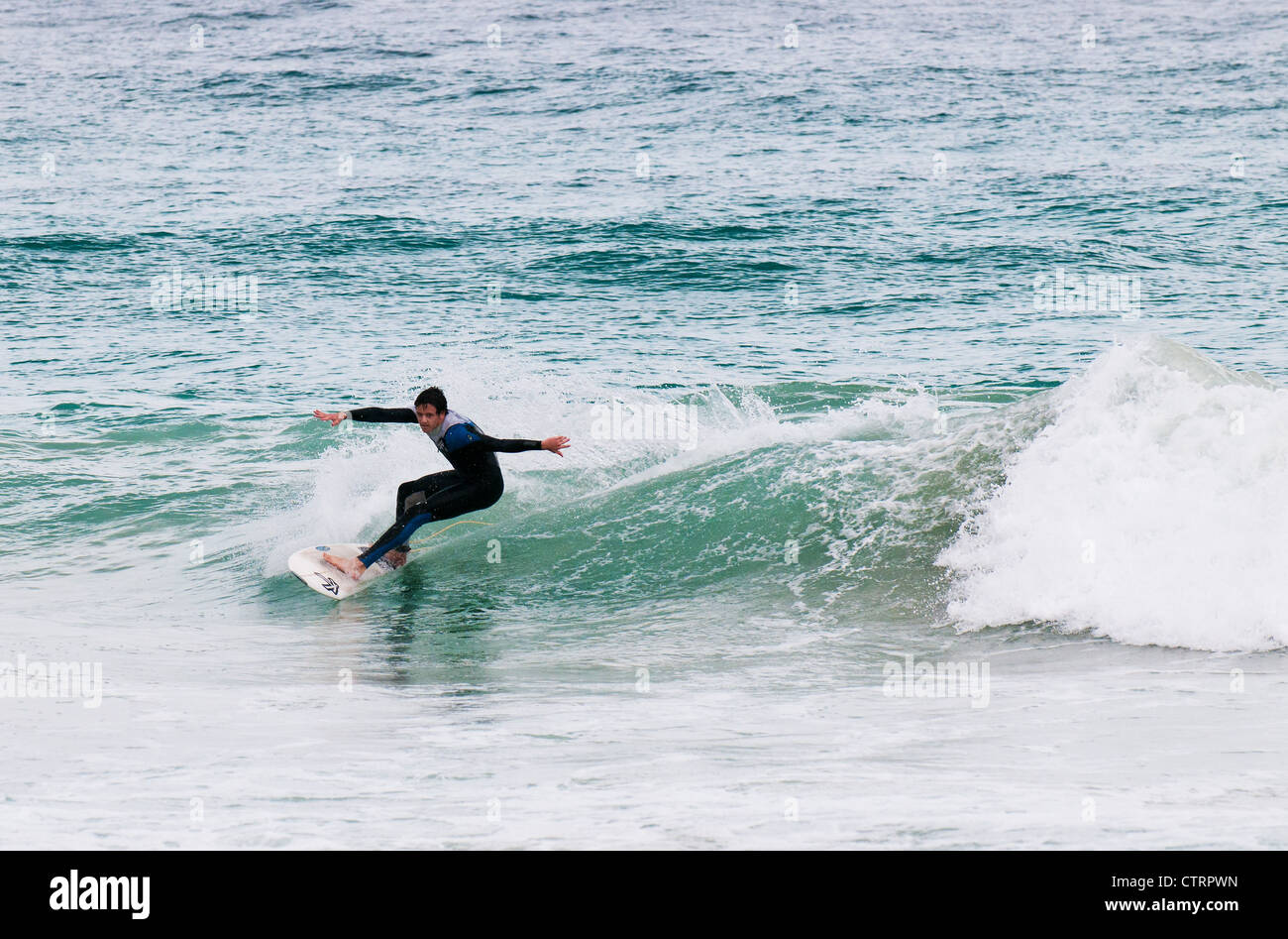A surfer off Trigg Beach in Western Australia. Stock Photo