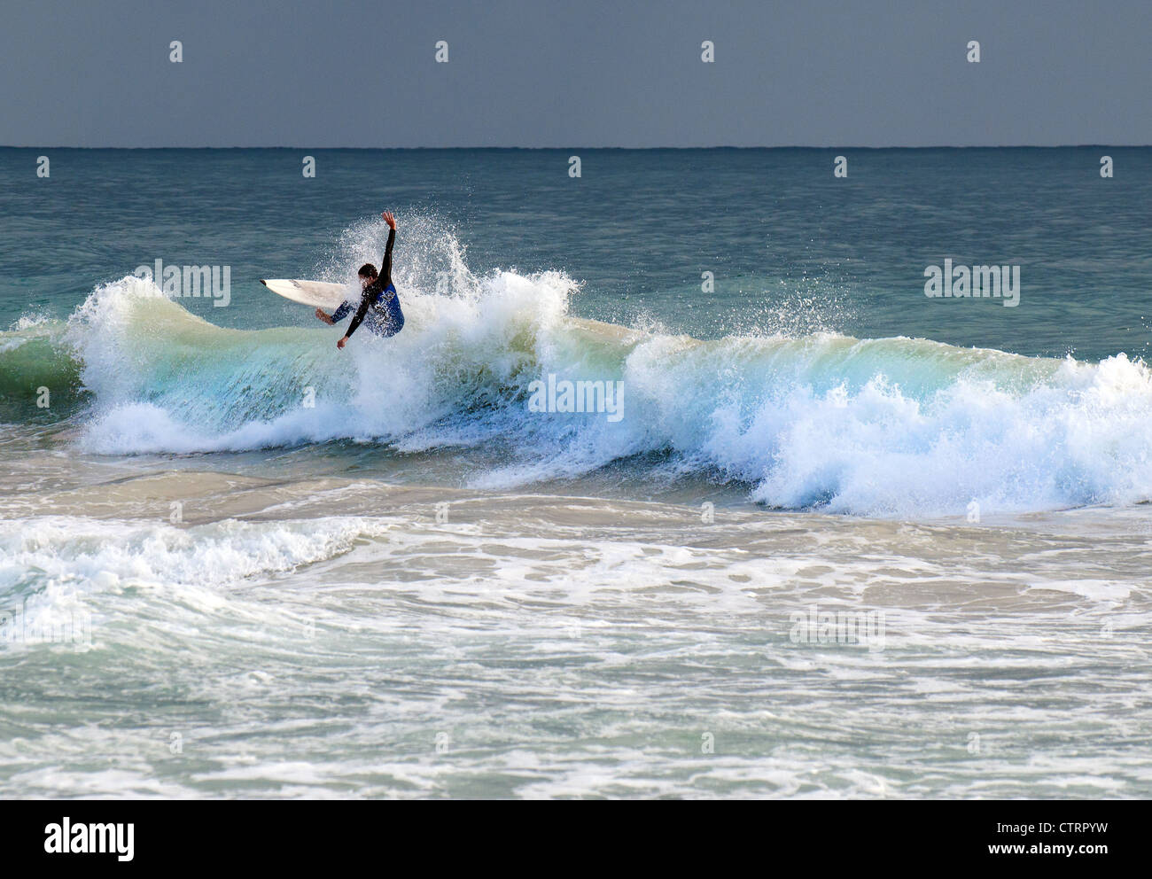 A surfer off Trigg Beach in Western Australia. Stock Photo