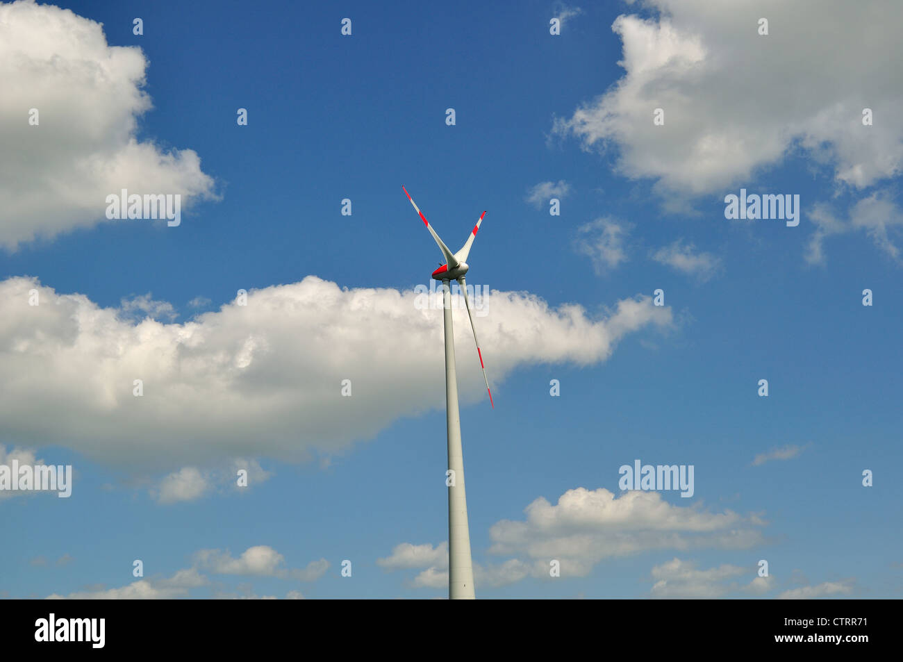 Wind turbine against blue sky Stock Photo - Alamy