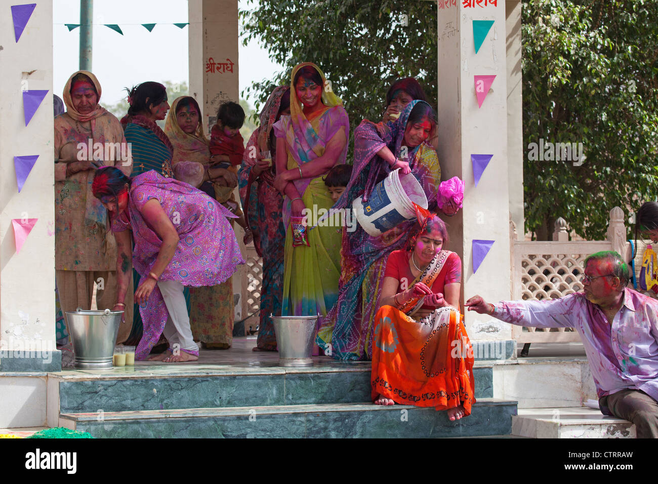 Women covered in colourful dye celebrating the Holi festival, Festival of Colours in Mathura, Uttar Pradesh, India Stock Photo