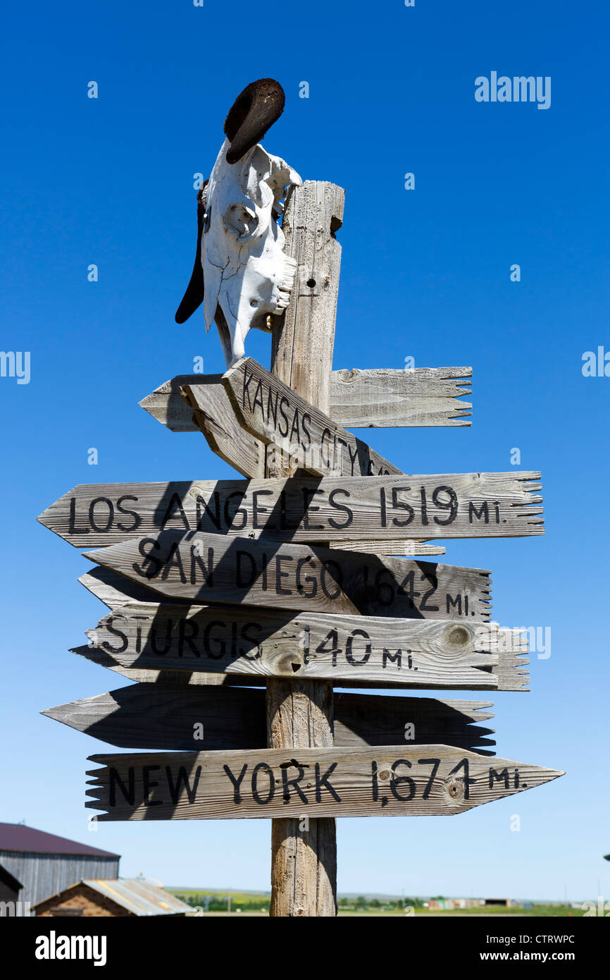 Signpost showing distances to major US cities in '1880 Town' western attraction in Murdo, South Dakota, USA Stock Photo