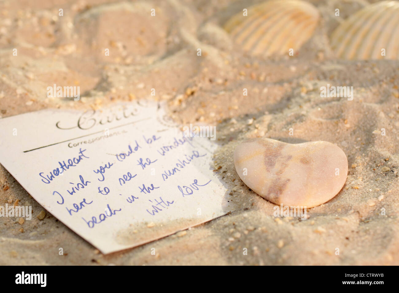 Heart with postcard and sea shells on the beach Stock Photo - Alamy
