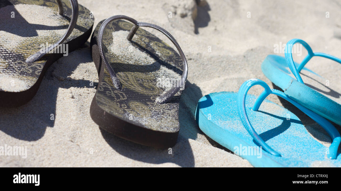 Flip flops on a beach Stock Photo - Alamy
