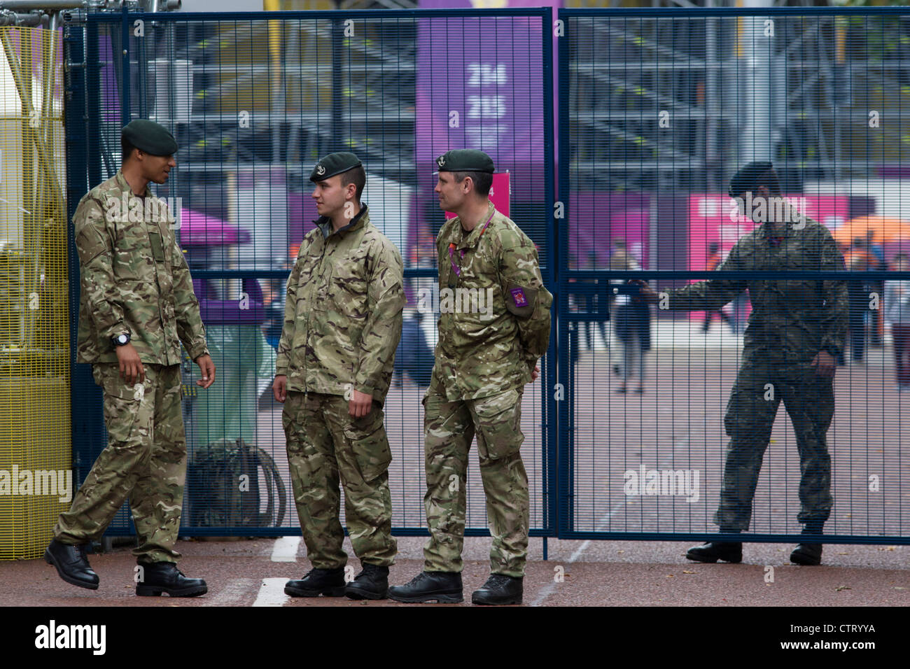 Soldiers of the Rifles regiment in the British army stand guarding the entrance to the volleyball venue in central London next to the IOC rings logo on day 4 of the London 2012 Olympic Games. A further 1,200 military personnel are being deployed to help secure the 2012 Olympics in London following the failure by security contractor G4S to provide enough private guards. The extra personnel have been drafted in amid continuing fears that the private security contractor's handling of the £284m contract remains a risk to the Games. Stock Photo