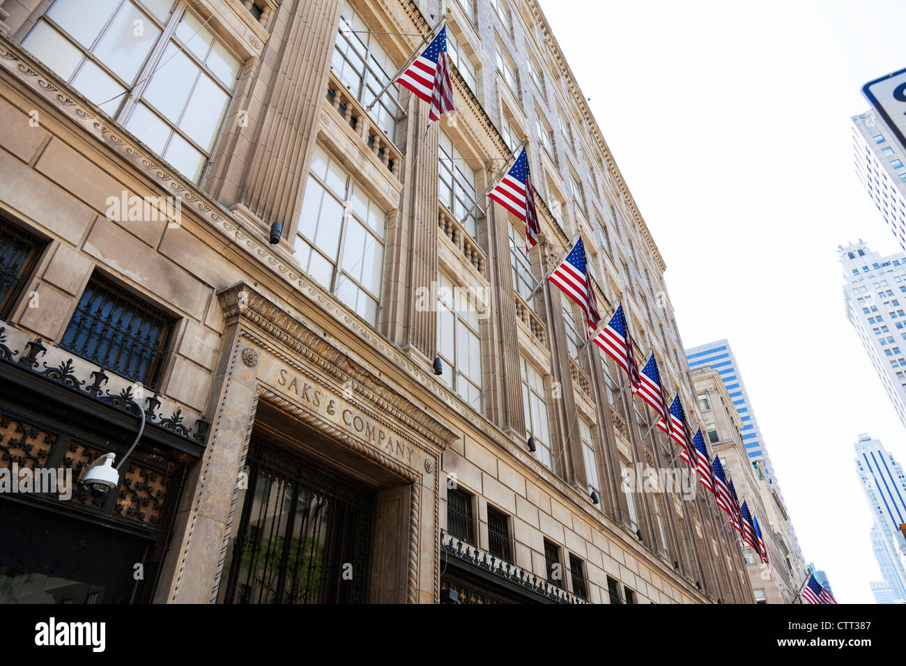 The Iconic American flags lined up outside Saks & Company classic New York City Department Store on Fifth Avenue Stock Photo