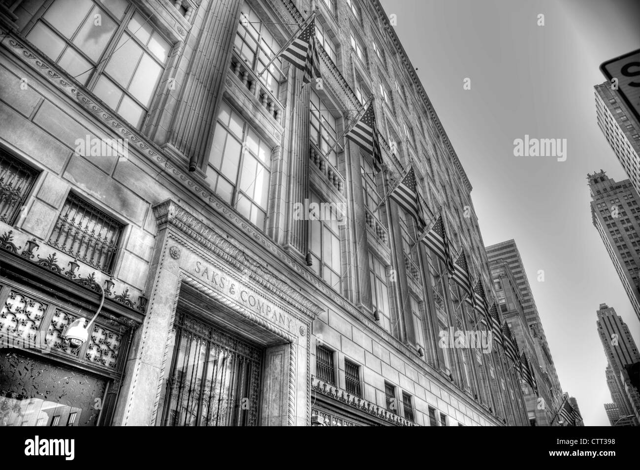 The Iconic American flags lined up outside Saks & Company classic New York City Department Store on Fifth Avenue Stock Photo