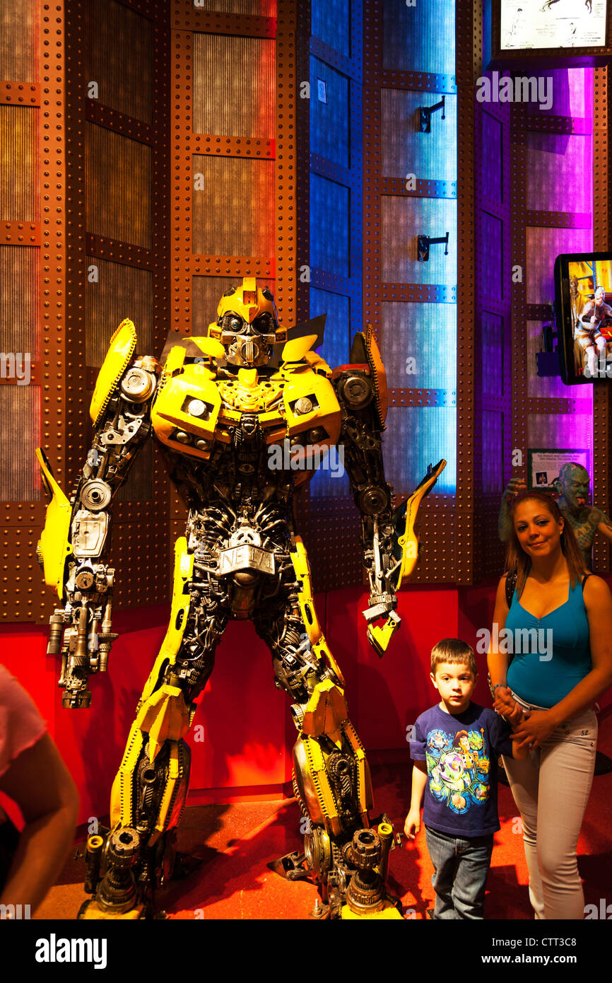 couple posing with Bumblebee the yellow transformer film character
