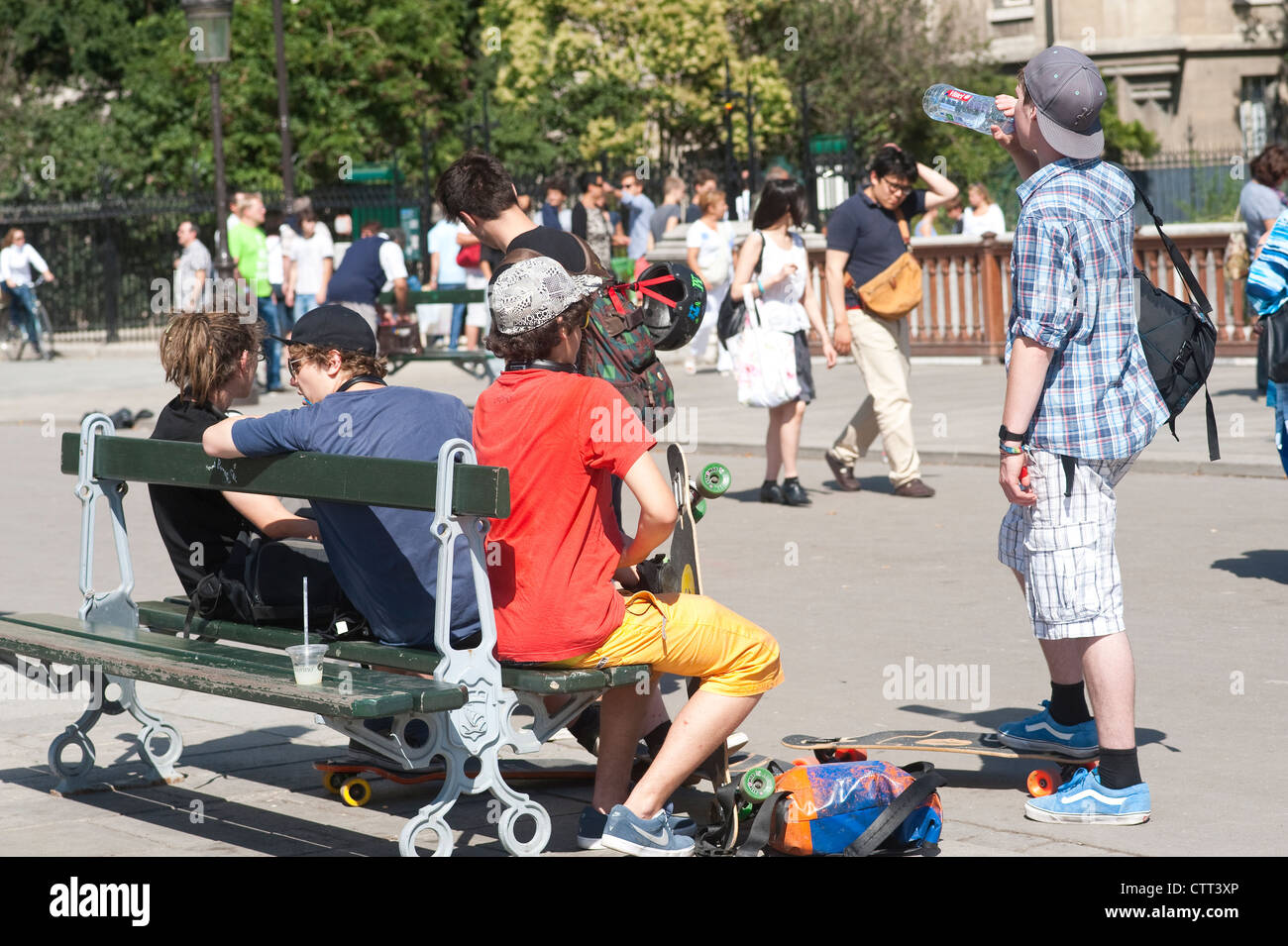 Paris, France - Young teen skateboarders sitting on  a bench in the Notre Dame area. Stock Photo