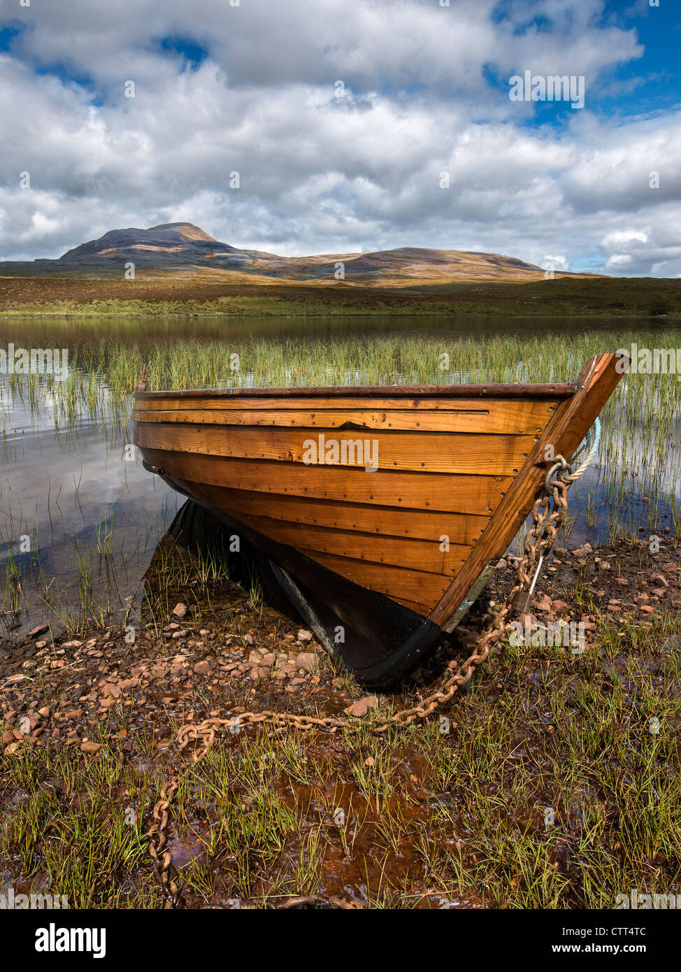 A wooden clinker built rowing boat used for fly fishing on a Scottish Loch Stock Photo