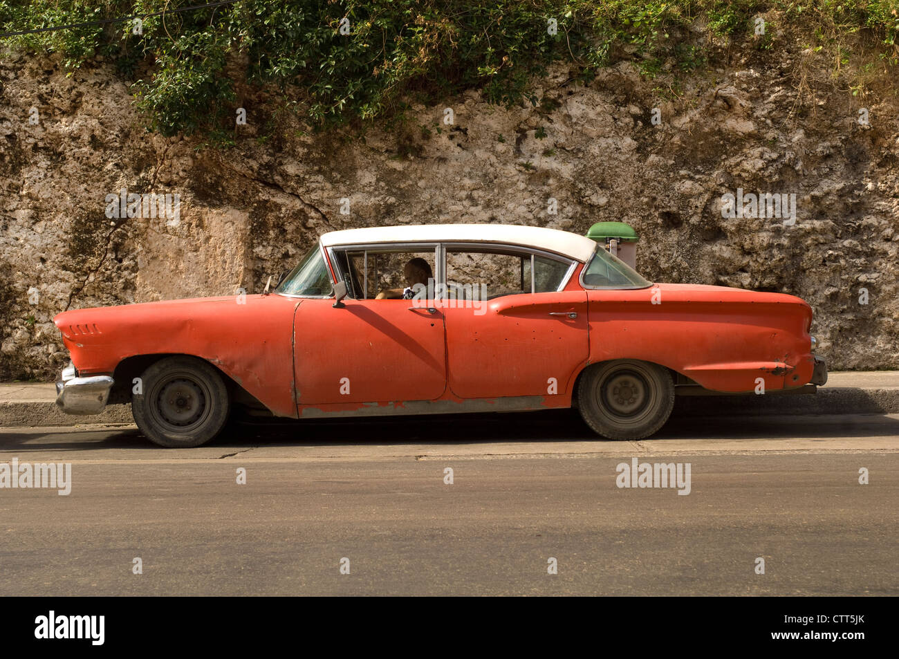 Old 1950's American car, possibly a Lincoln, parked in a side street in Havana, Cuba Stock Photo