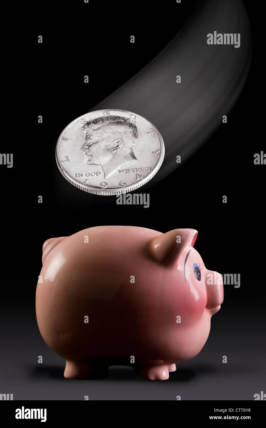 Pink Piggy Bank with Silver Kennedy Half Dollar. Stock Photo
